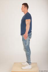 Whole body blue tshirt light blue jeans modeling a pose of Andrew